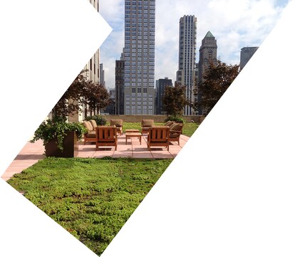 Urban rooftop terrace with lounge chairs and city buildings