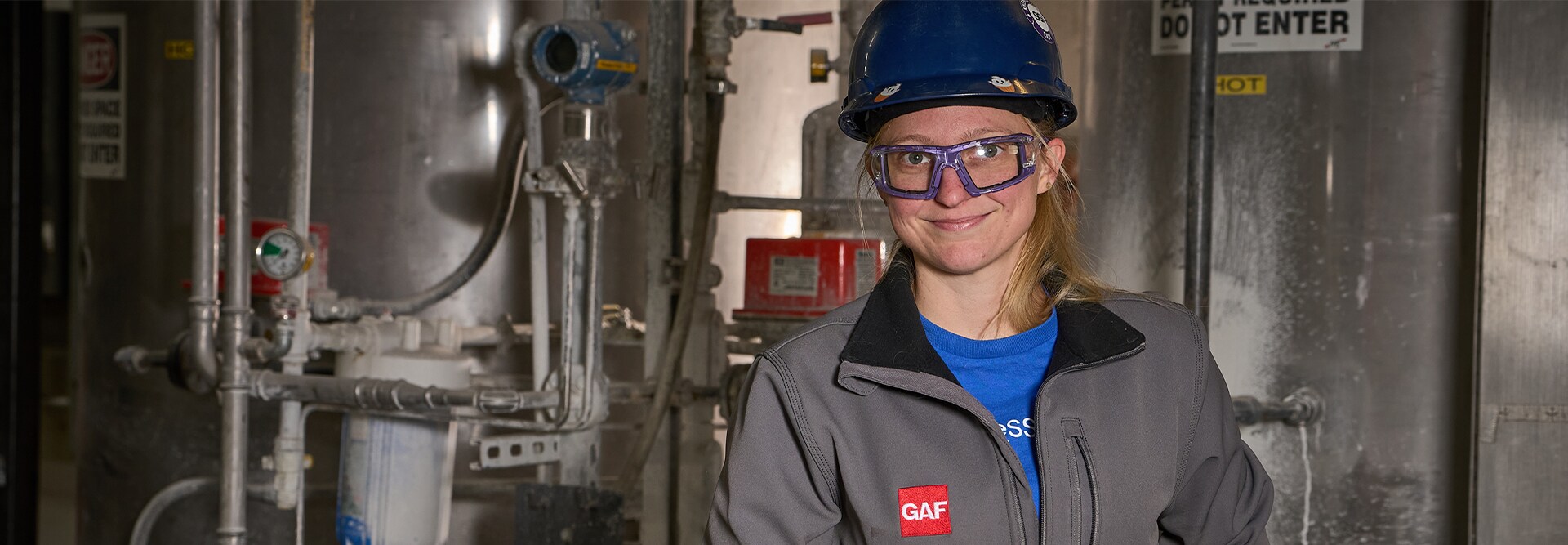 GAF employee wearing a hard hat and a GAF brand jacket at the Minneapolis plant.