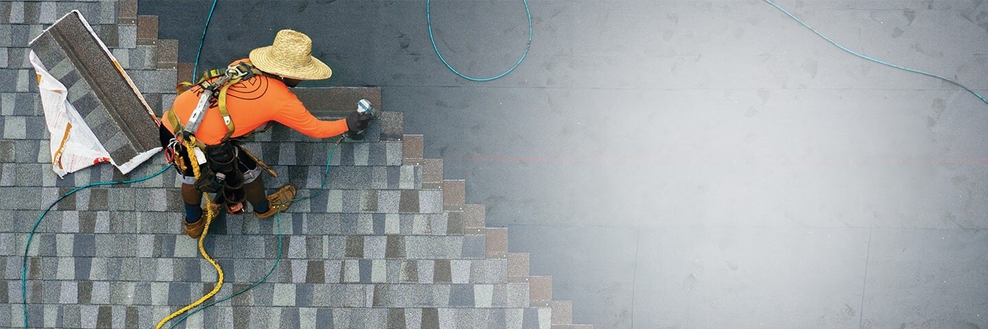 Roofing contractor nailing GAF roof shingles