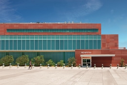 the front of a hospital featuring a complex roof